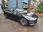 2018 Tesla Model 3 Mid Range RWD in excellent condition, showcasing sleek black exterior and new tires.