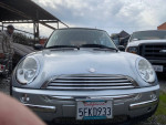 Front view of a 2004 MINI Cooper in silver with license plate, needing a clutch replacement.