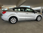2012 Kia Rio with low mileage and clean title, parked in a garage.