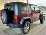 2010 Jeep Rubicon Unlimited with 114,000 miles, remote start and off-road features, parked in a garage.
