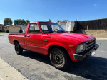 1983 Toyota Pickup in red, single owner, excellent condition, manual transmission, reliable 22R engine.