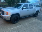 2012 GMC Sierra 1500 SLT 4WD parked with black wheels, featuring heated leather seats and aftermarket upgrades.
