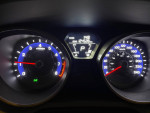 Dashboard of a 2013 Hyundai Elantra showing speedometer and fuel gauge with 124,528 km