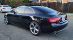 2010 Audi A5 3.2 Premium Plus quattro in black, parked on a street with sporty wheels.