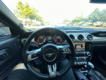 Interior view of a 2015 Mustang GT 50th anniversary edition with modern dashboard and controls.