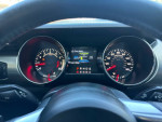 Interior view of a 2015 Ford Mustang GT with speedometer and fuel gauge displays showing 117,000 miles
