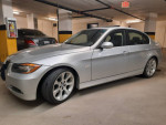 2006 BMW 330i in silver color, parked in a warm underground garage, well-maintained with service records.