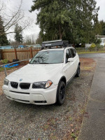 2006 BMW X3 parked outdoors, showing some wear and tear, ideal for buyers looking for an affordable SUV.