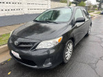 2012 Toyota Corolla LE in black, showing exterior design and condition, available for sale with 92,000 miles.