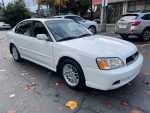 2004 Subaru Legacy sedan in white, featuring clean title and 129,000 miles, parked in Hayward.