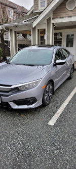 2016 Honda Civic EX sedan in silver with sunroof parked, featuring eco mode and advanced safety systems.