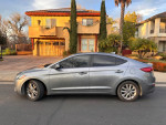 2017 Hyundai Elantra Eco FWD in excellent condition, parked on the street with modern architecture in the background.