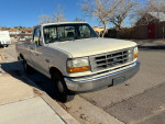 1992 Ford F-150 with clean exterior, long bed, and new tires parked on the street