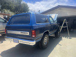 1990 Dodge Ramcharger 4x4 with restoration features parked outdoors, showcasing blue exterior and new tires.