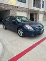 2007 Nissan Altima 3.5 SE in blue parked in driveway, showcasing its sleek design and clean exterior.