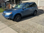 Blue 2009 Subaru Forester 2.5X AWD parked on driveway showcasing its clean exterior and modern design.