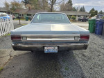 Rear view of a 1967 Plymouth Satellite with original features and new updates parked on a gravel driveway.