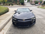 Front view of a 2017 Chevrolet Camaro 2LT Convertible in black, showcasing sleek design and sharp headlights.