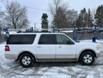 2009 Ford Expedition Eddie Bauer parked in snow, reliable family SUV with ample seating and space.