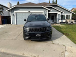 Front view of a black 2020 Jeep Cherokee Limited parked in a driveway.