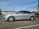 2014 Ford Fusion SE in silver, featuring black cloth interior, 17'' alloy wheels, and power amenities.