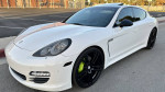 2011 Porsche Panamera 4 in white with black leather interior parked on street, showcasing modern design and alloy wheels.