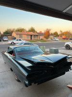Rear view of a classic 1959 Chevrolet Impala, showcasing new paint and chrome bumpers.