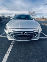 Front view of a 2019 Hyundai Elantra SEL in silver parked, showcasing its stylish design and features.