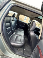 Interior view of a 2008 Volvo V70 showcasing spacious black leather back seats.