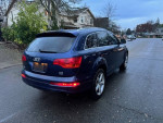 2008 Audi Q7 S-Line in blue, 89K miles, parked on a wet street with houses in the background.
