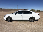 2018 Volkswagen Jetta SE in White, displaying sleek design and modern features, parked in a gravel area.