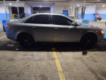 2007 Audi A4 Quattro with black rims parked in a garage with low lighting.