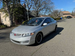 2011 Honda Civic Coupe in silver parked on the street, showing clean exterior and low mileage.