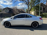 2011 Honda Civic Coupe in silver parked on the street, showcasing low mileage and clean condition.