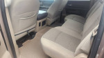 Interior view of a 2010 Dodge Ram 1500 Big Horn with spacious seating in beige fabric.