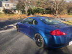 Blue 2003 Infiniti G35 Coupe parked on a street, showcasing its stylish design and rear wheel drive features.