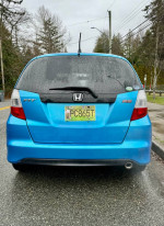 Rear view of a 2009 Honda Fit Sport in blue, showcasing clean condition and unique features.