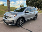 2020 Honda Pilot Touring in excellent condition with low mileage and advanced features parked outdoors