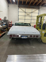 1968 Chevrolet Impala Custom Coupe parked in a garage with minimal wear and tear, ready for restoration.