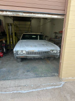 Front view of a 1968 Chevrolet Impala Custom Coupe parked in garage with minimal wear.