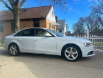 Side view of a 2013 Audi A4 in good condition, showcasing its exterior design and features.