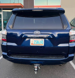 Rear view of a 2014 Toyota 4Runner SR5 RWD parked, showcasing its blue color and hitch receiver.
