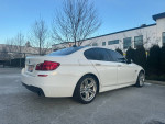 2011 BMW 535xi M-sport Sedan in Alpine white, showing sporty design and luxury features.