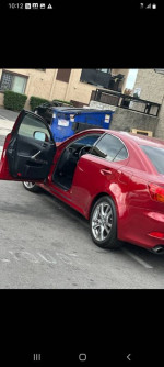 2006 Lexus IS 250 RWD in red, showcasing clean exterior and open door, ready for serious buyers.