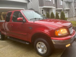 1999 Ford F-150 XLT 4WD in red with low mileage, well-maintained and ready for new adventures.