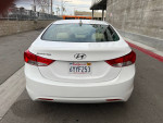 Rear view of a white 2014 Hyundai Elantra with California license plate, clean condition and well-maintained.