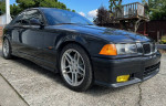 1995 BMW M3 Dinan Supercharged in excellent condition, showcasing sleek black exterior and sporty wheels.