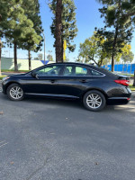 2015 Hyundai Sonata Eco FWD in black, parked with pristine exterior and alloy wheels, featuring modern design.