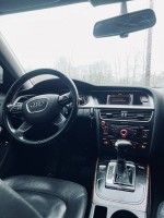 Interior view of a 2013 Audi A4 2.0T Premium with leather seats and advanced dashboard features