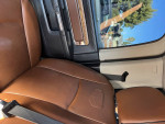 Interior view of a 2014 Ram 3500 Longhorn with brown leather seats and modern design.